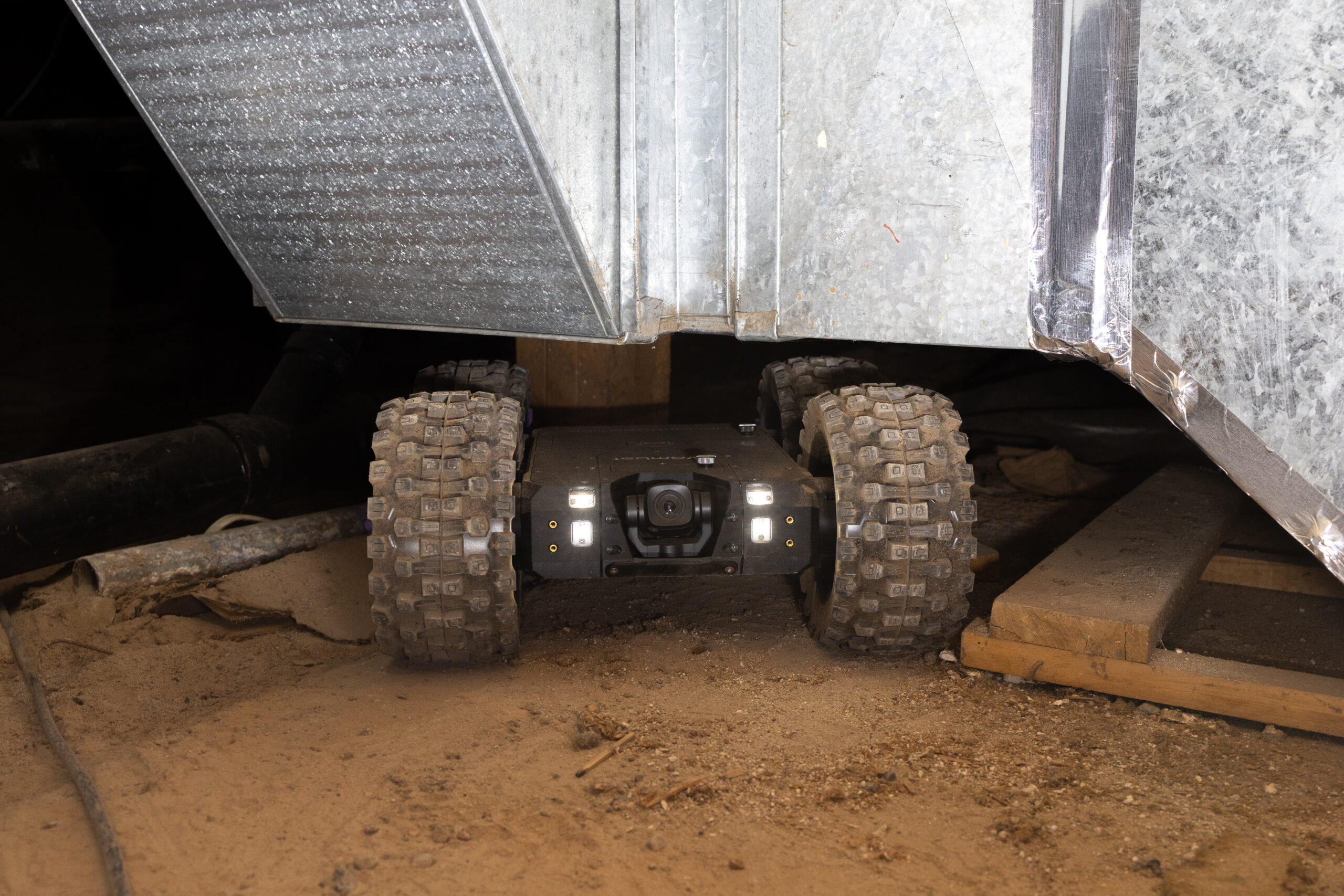 1. Crawlspace inspection robot evaluating an inaccessible area beneath a home
